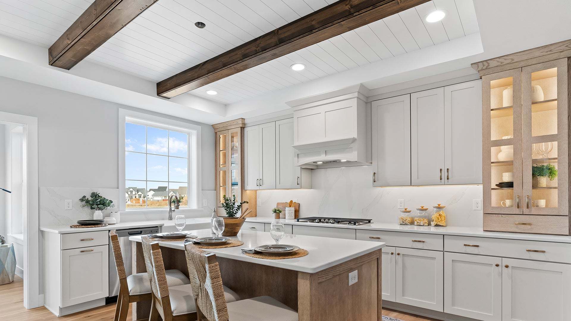 Kitchen with Beamed Ceiling and Light Wood Accents in a Customized Kingston New Home in Ephrata PA