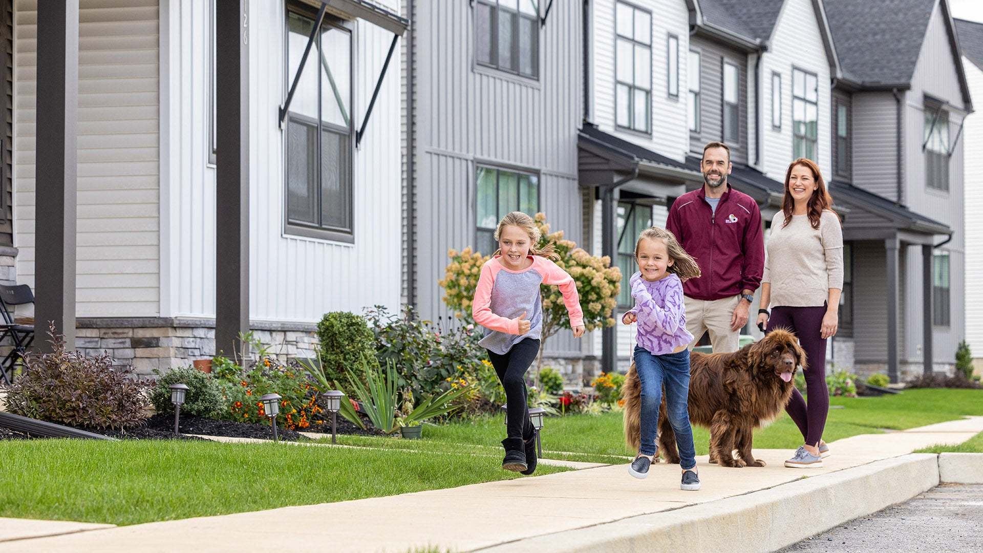 Family Walking with Dog at Madison Court New Townhome Community in Mechanicsburg