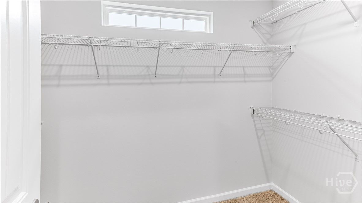 One of two primary walk in closets