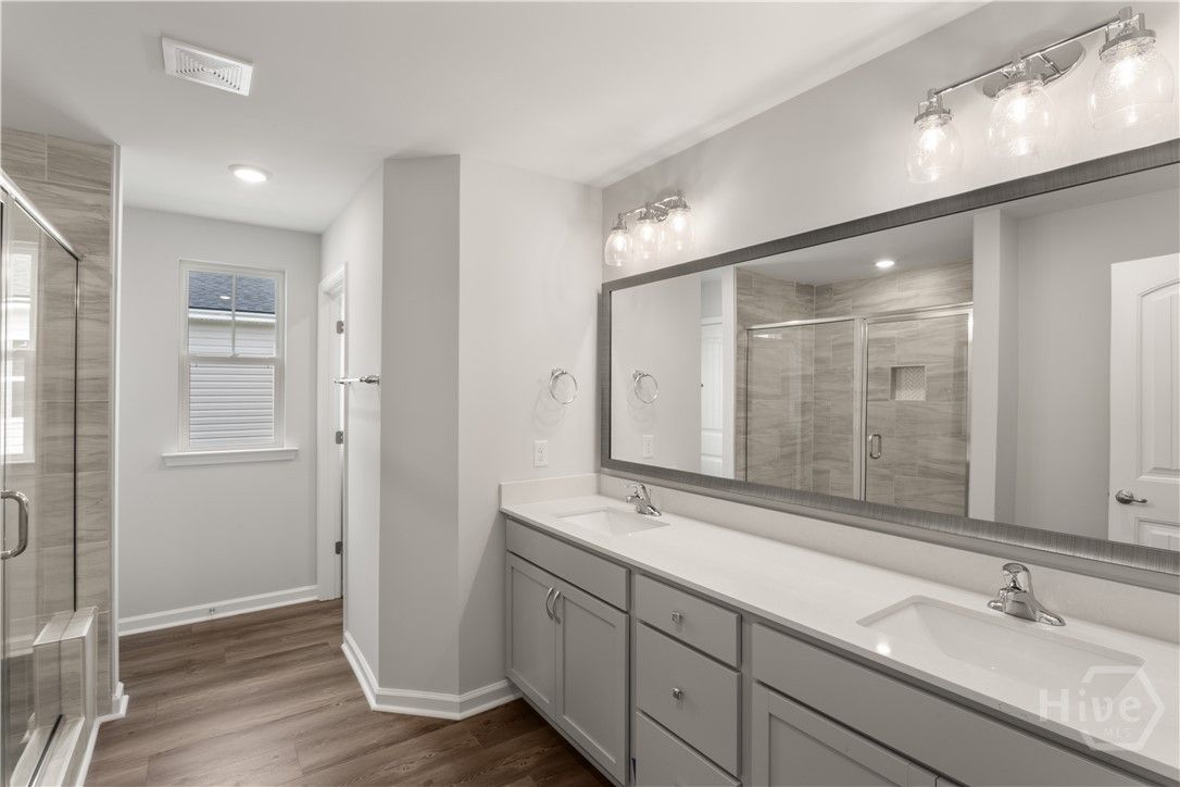 Primary bathroom features double vanities w/ a qua
