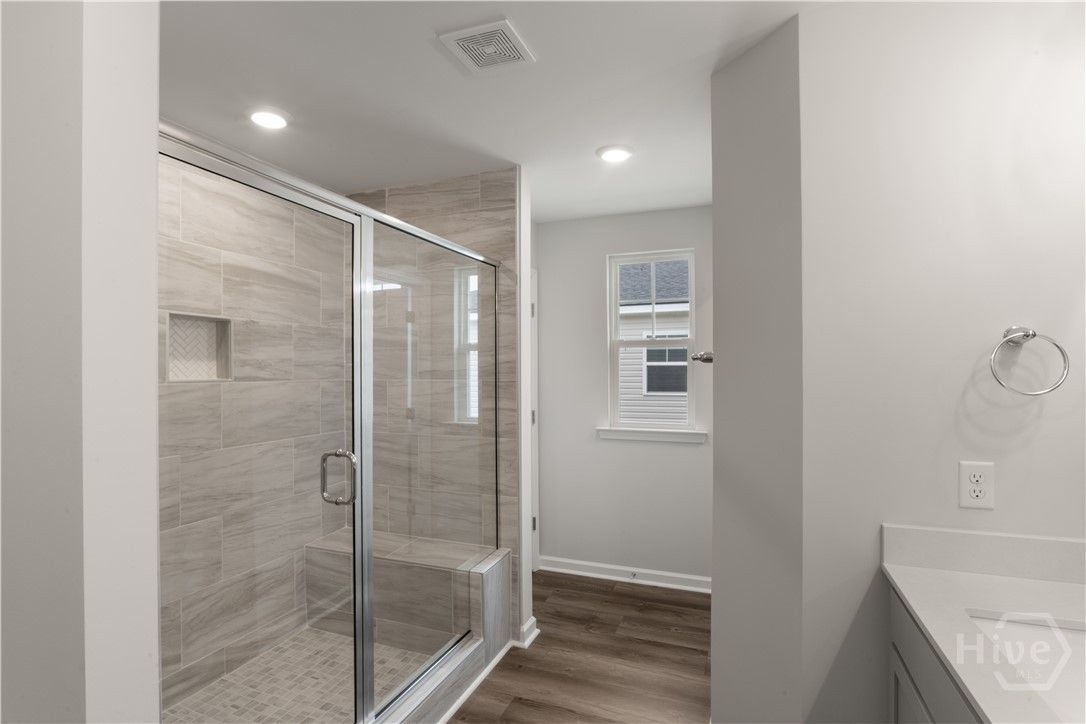Primary bathroom features double vanities w/ a qua