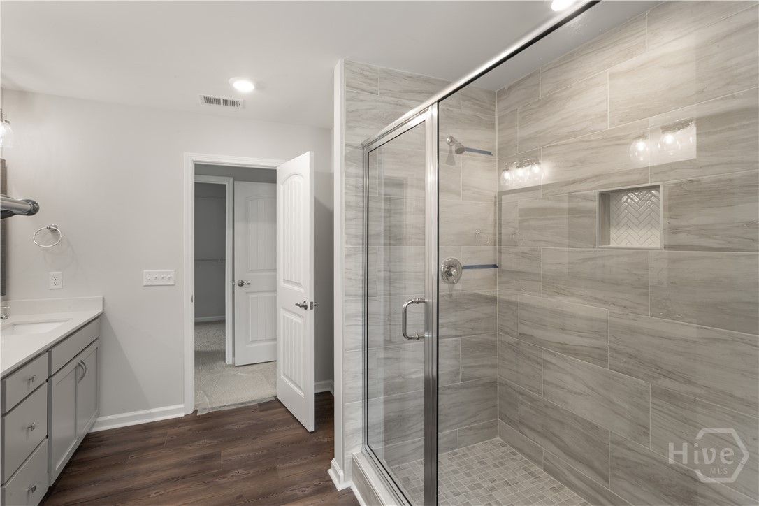 Primary bathroom features double vanities w/ a qua