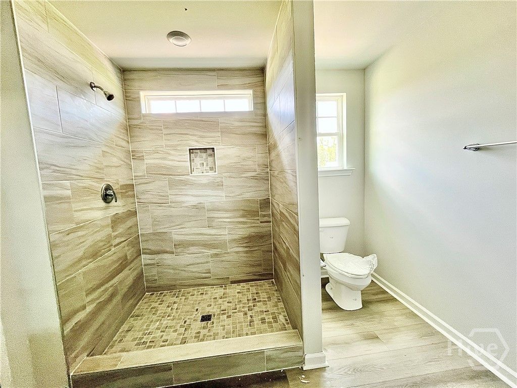 Primary bathroom. 5' tiled shower with a niche. Ph