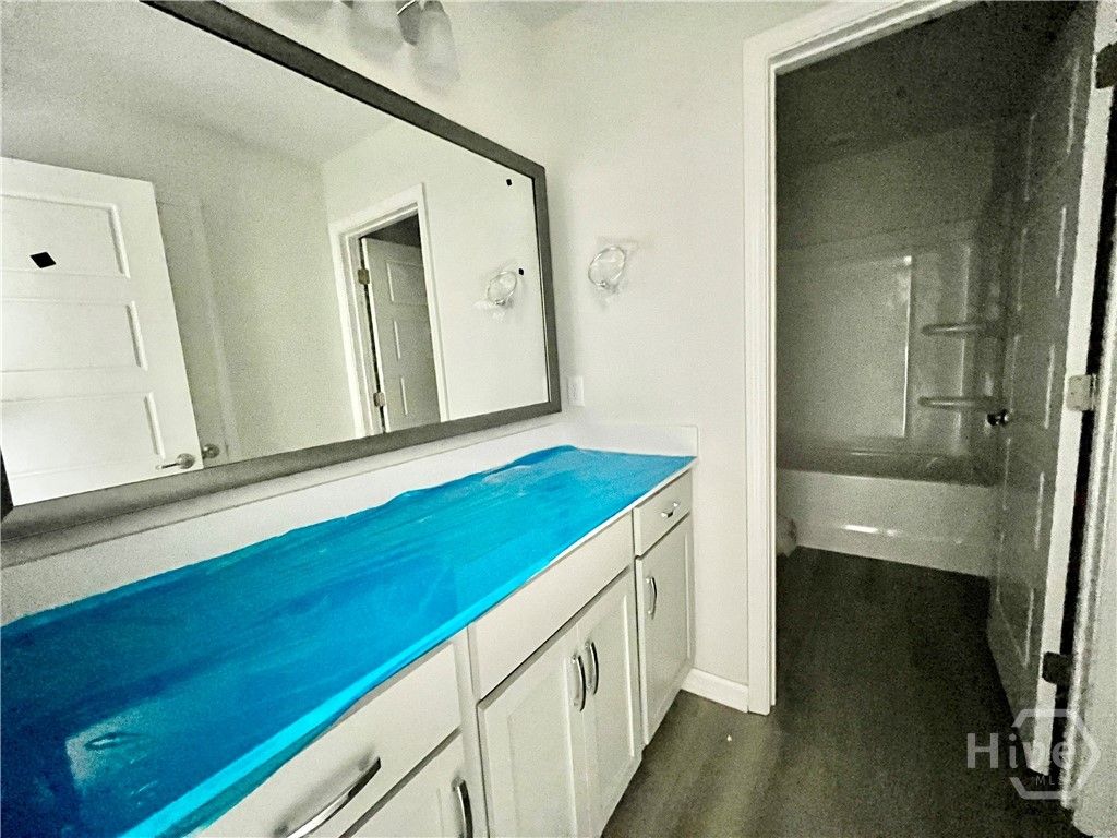 Hall bathroom. Quartz vanity and framed mirror! Ph