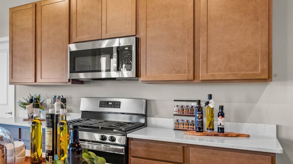 Designer-selected cabinetry in the kitchen provides abundant storage room