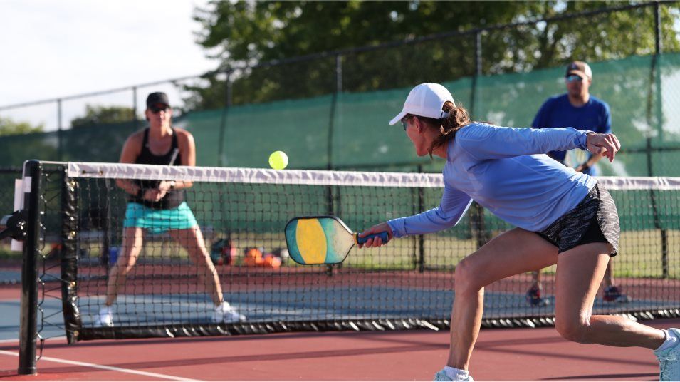 Adults playing pickleball