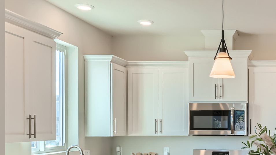 Kitchen cabinetry with crown moulding and brushed nickel hardware