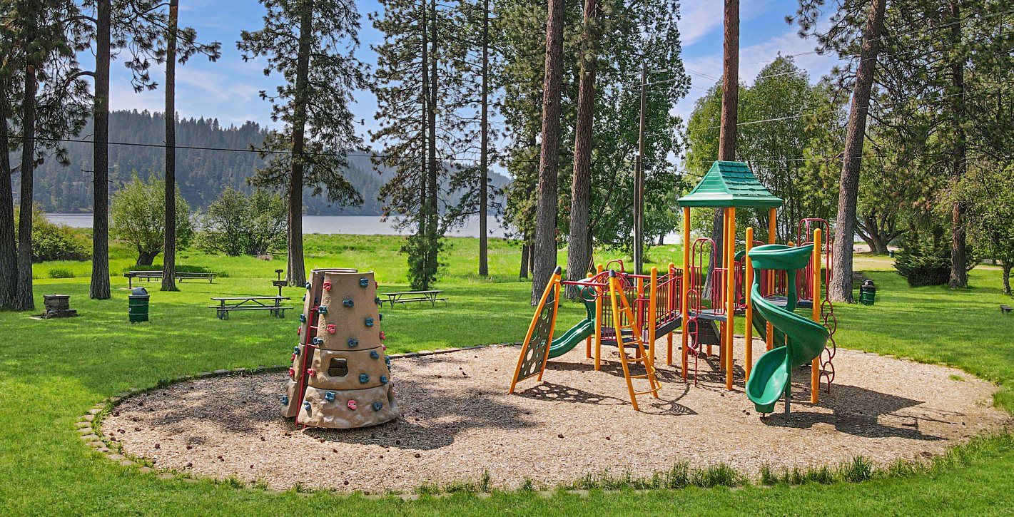 Playset and small rock climbing structure at a park