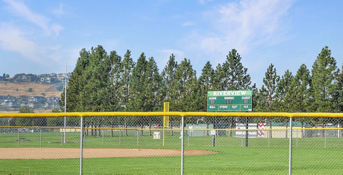 Little League field with scoreboard visible