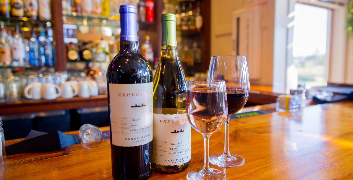Close up of wine bottles on a counter at a local eatery