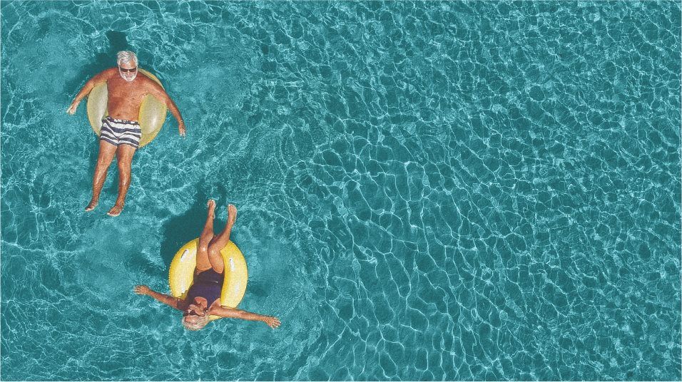 Adults floating in pool