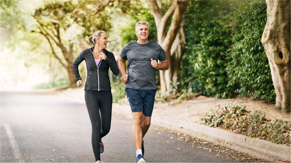 Couple jogging down a trail