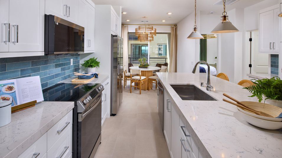 Sleek quartz countertops and cabinetry throughout the kitchen