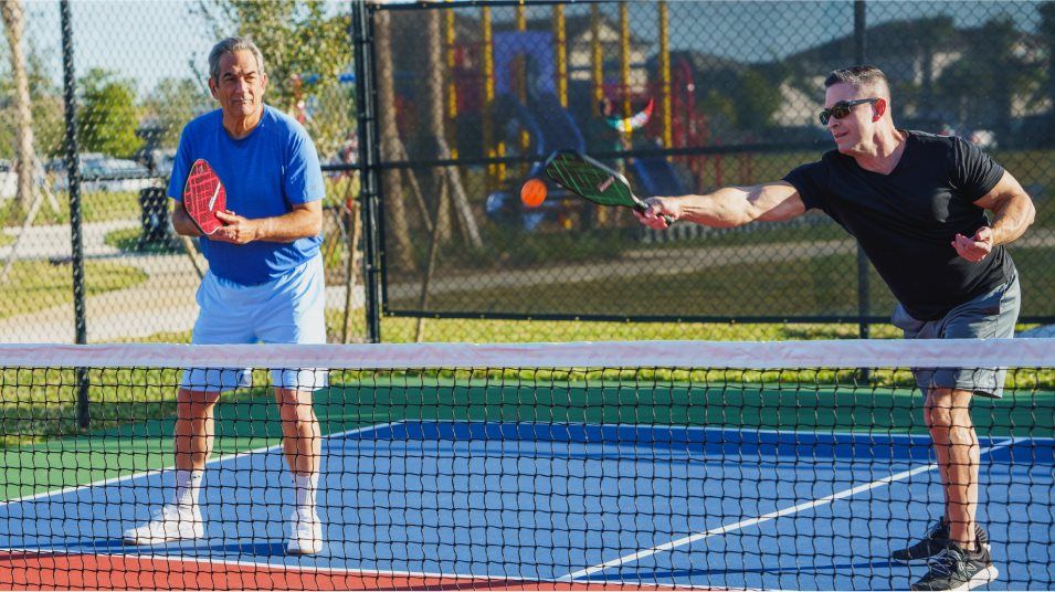 Two men playing pickleball