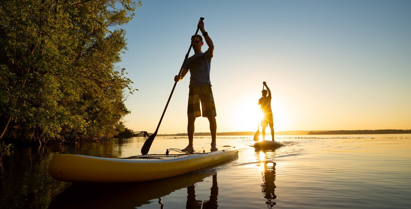 Friends paddle boarding