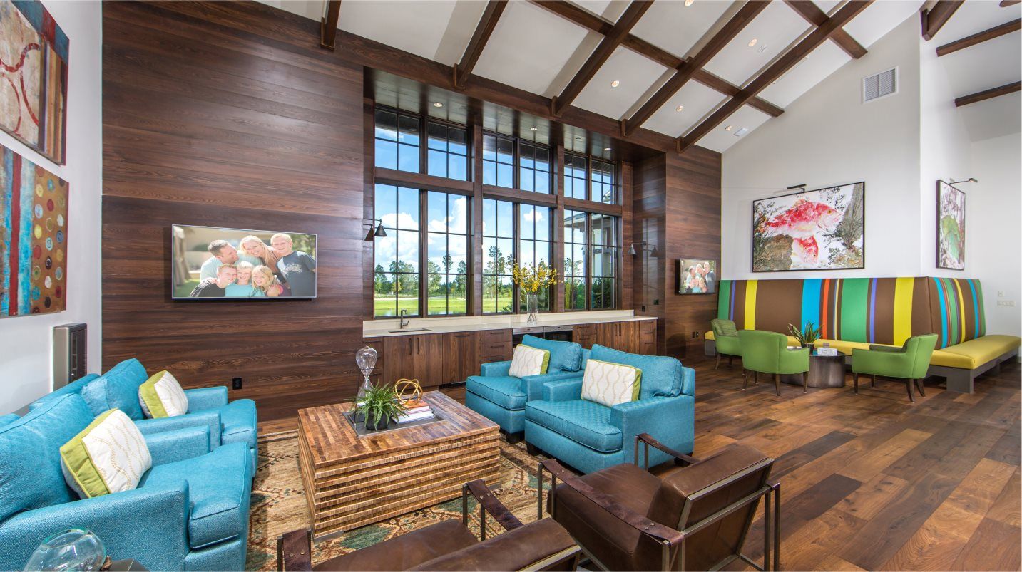 Club room with vibrant lounge furniture, televisions and sink station