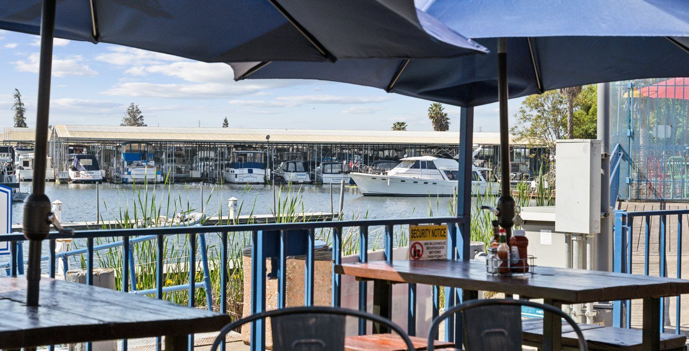 Outdoor seating on a balcony overlooking the water