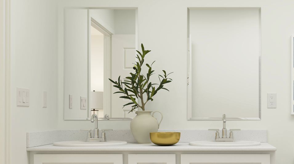 Beveled glass vanity mirrors over each sink in the owner's suite bathroom