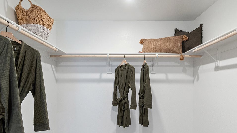 Walk-in closet with wood shelving and rods