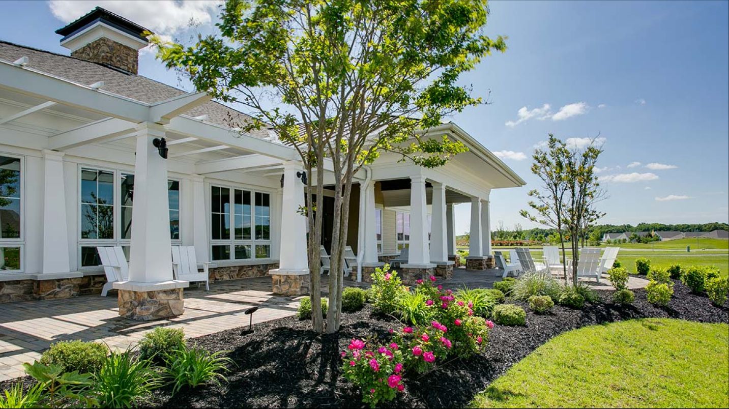 Community center exterior, shaded by trees