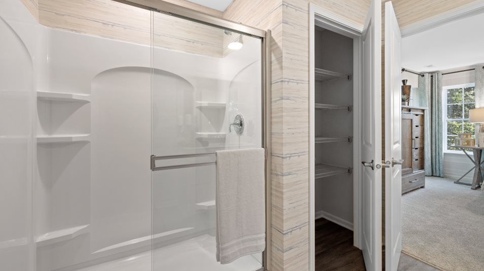 Darcy Fiberglass shower with clear glass door, brushed nickel trim and built-in shelving in owner's
