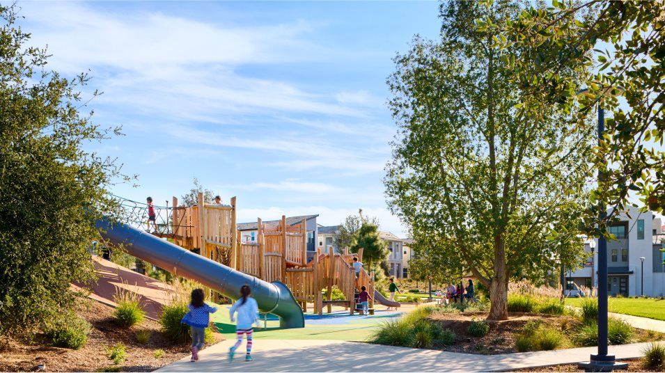 Two kids running toward a community playground