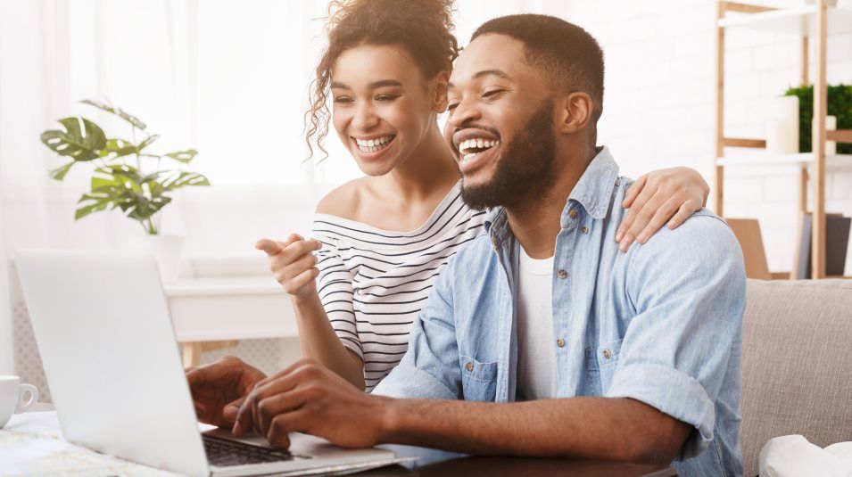 Couple in front of a laptop