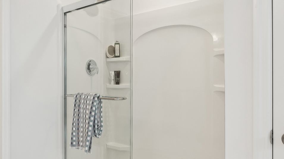Owners Suite bathroom Glass-enclosed shower with chrome fixtures