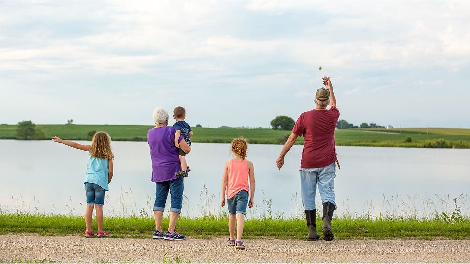 N Pic Grandparents Outdoors Grandkids Throwing Rocks Pond