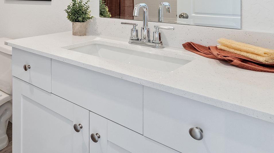 White quartz countertops with backsplash in the secondary bathroom