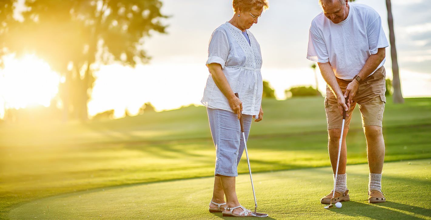 Active adults playing golf