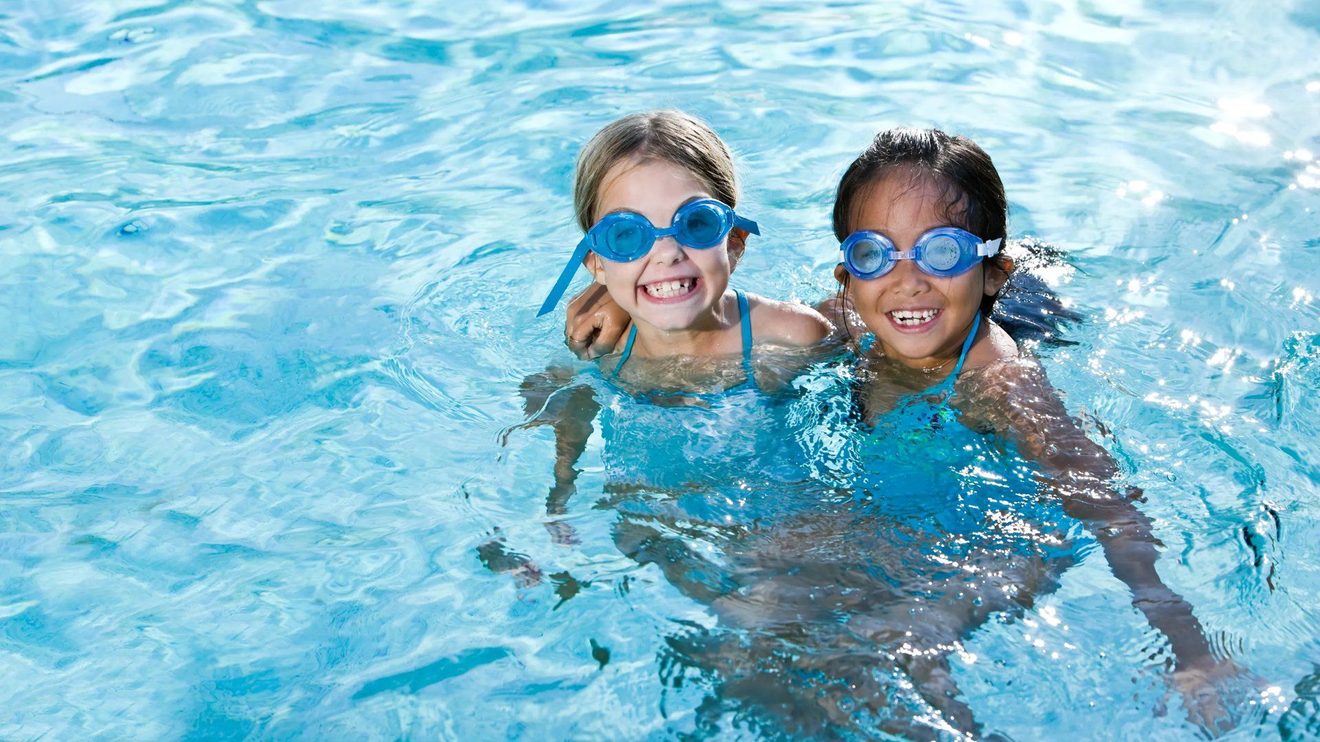 Swimming pool with smiling kids