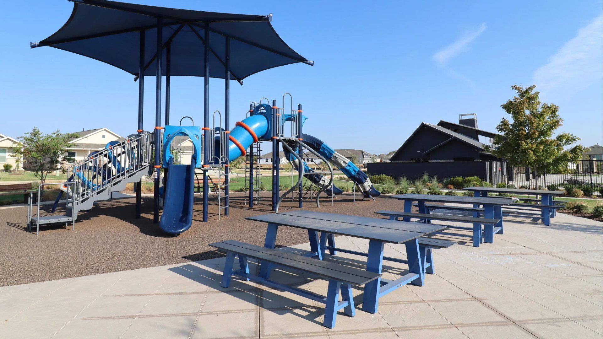 Blue playground and picnic tables