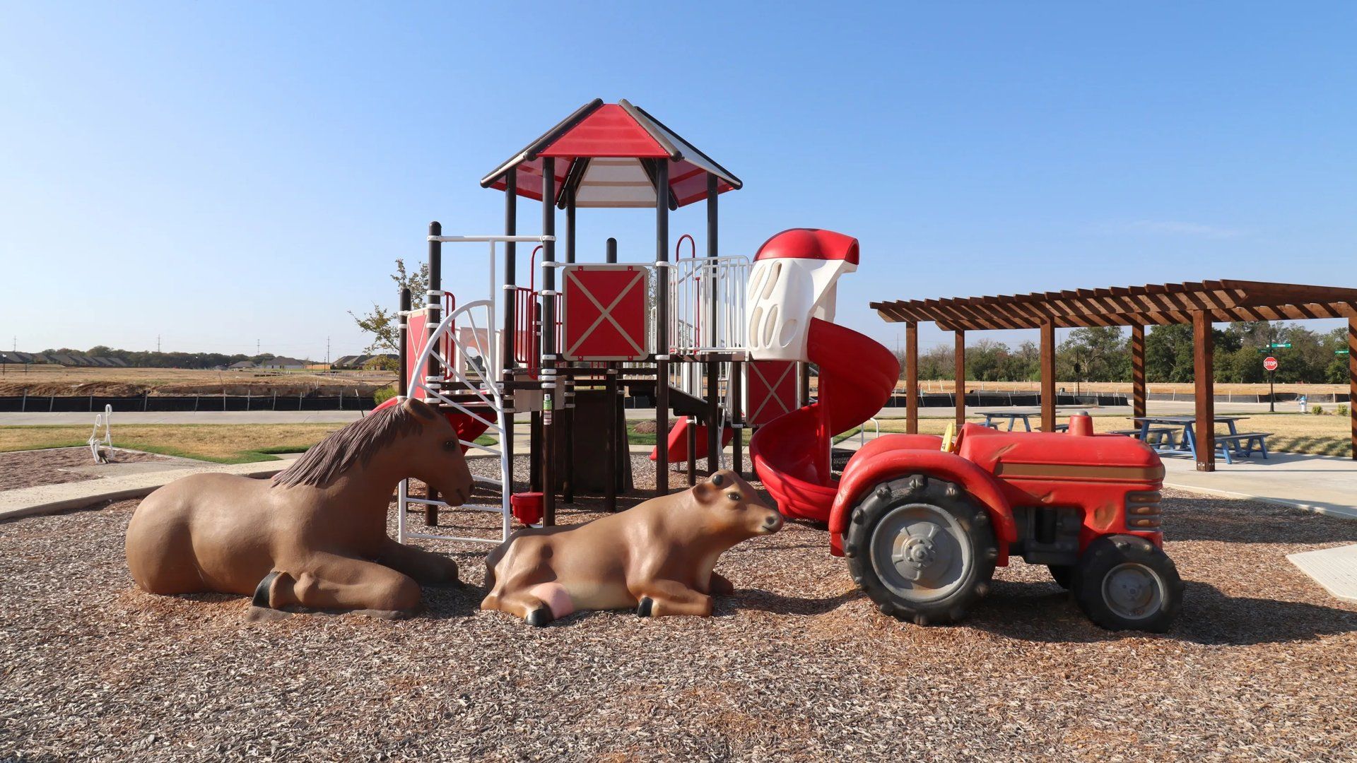 Red playground with horse, baby bull and tractor decor