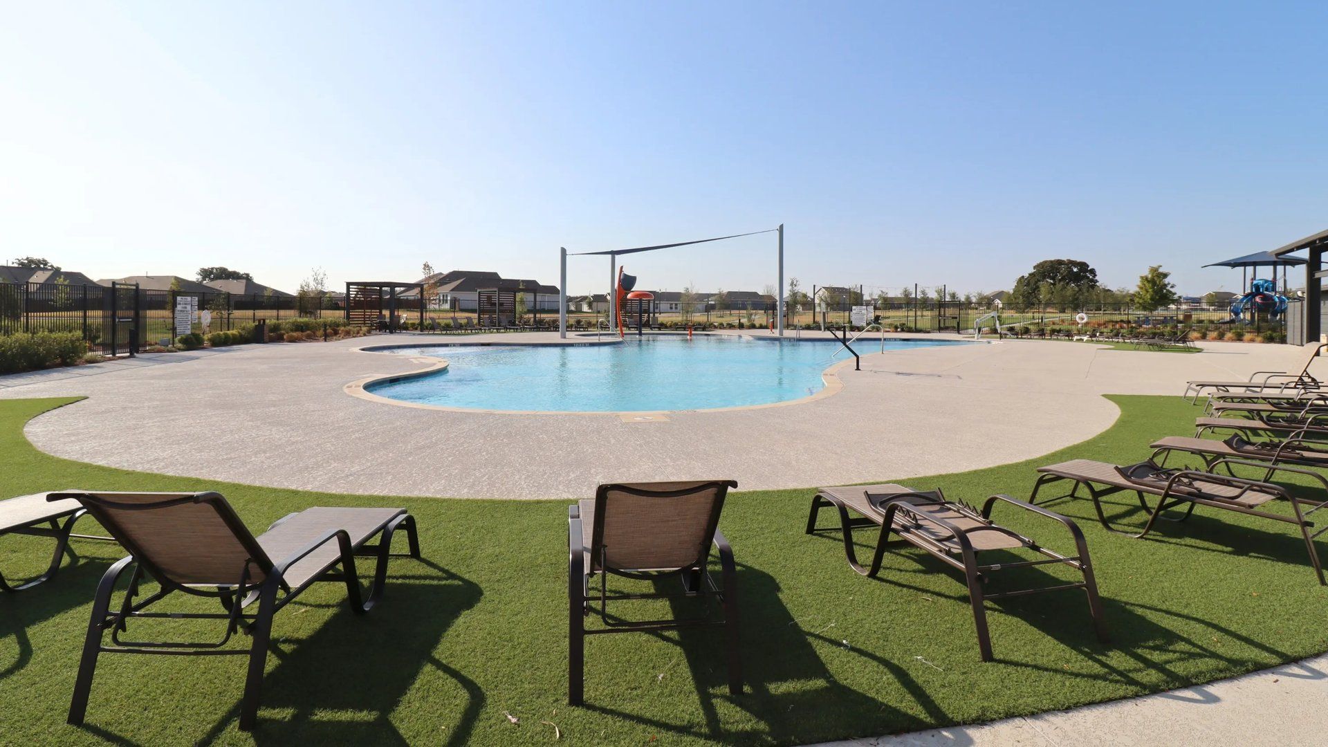 Wide view of lounge chairs and pool