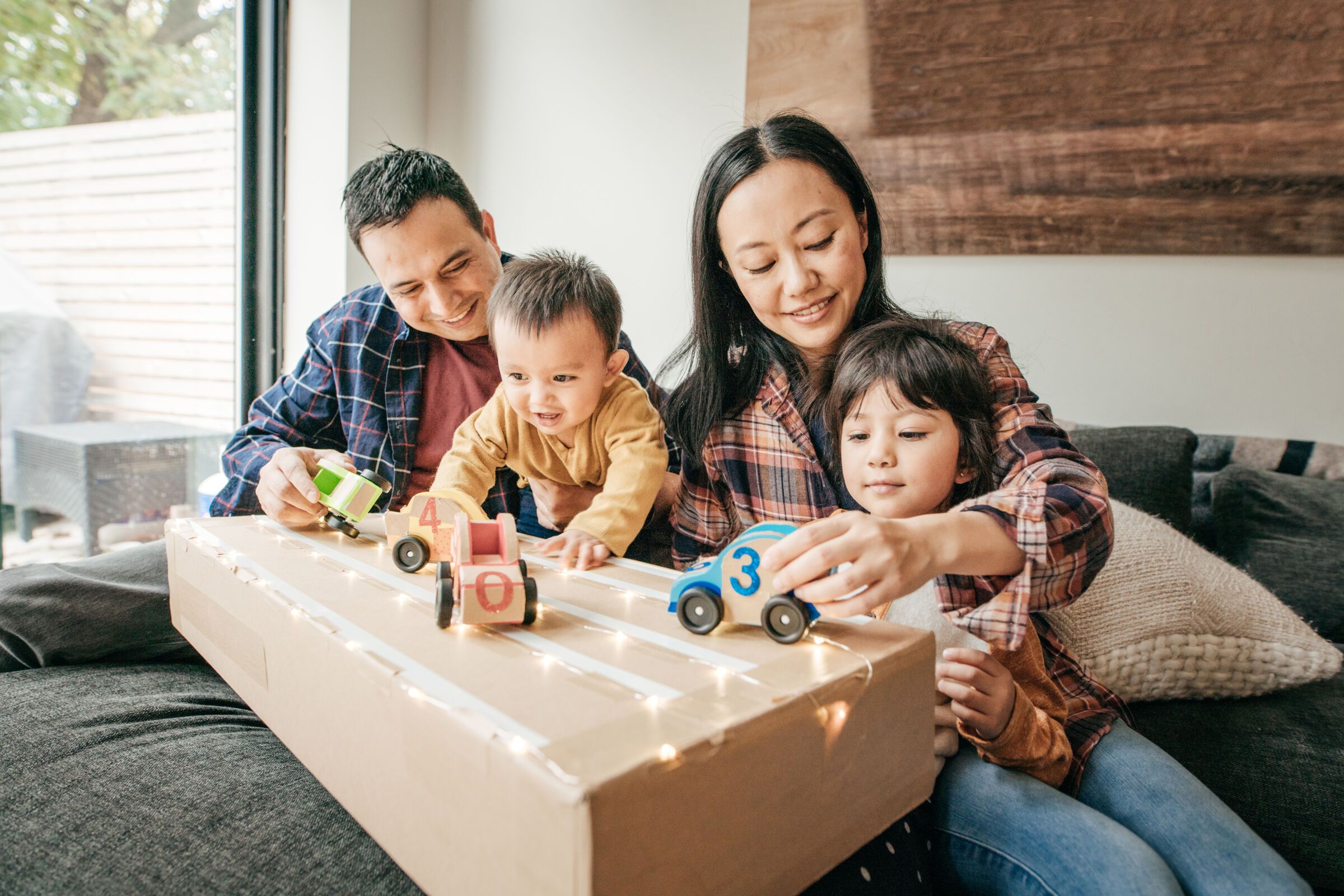Family playing with toy cars