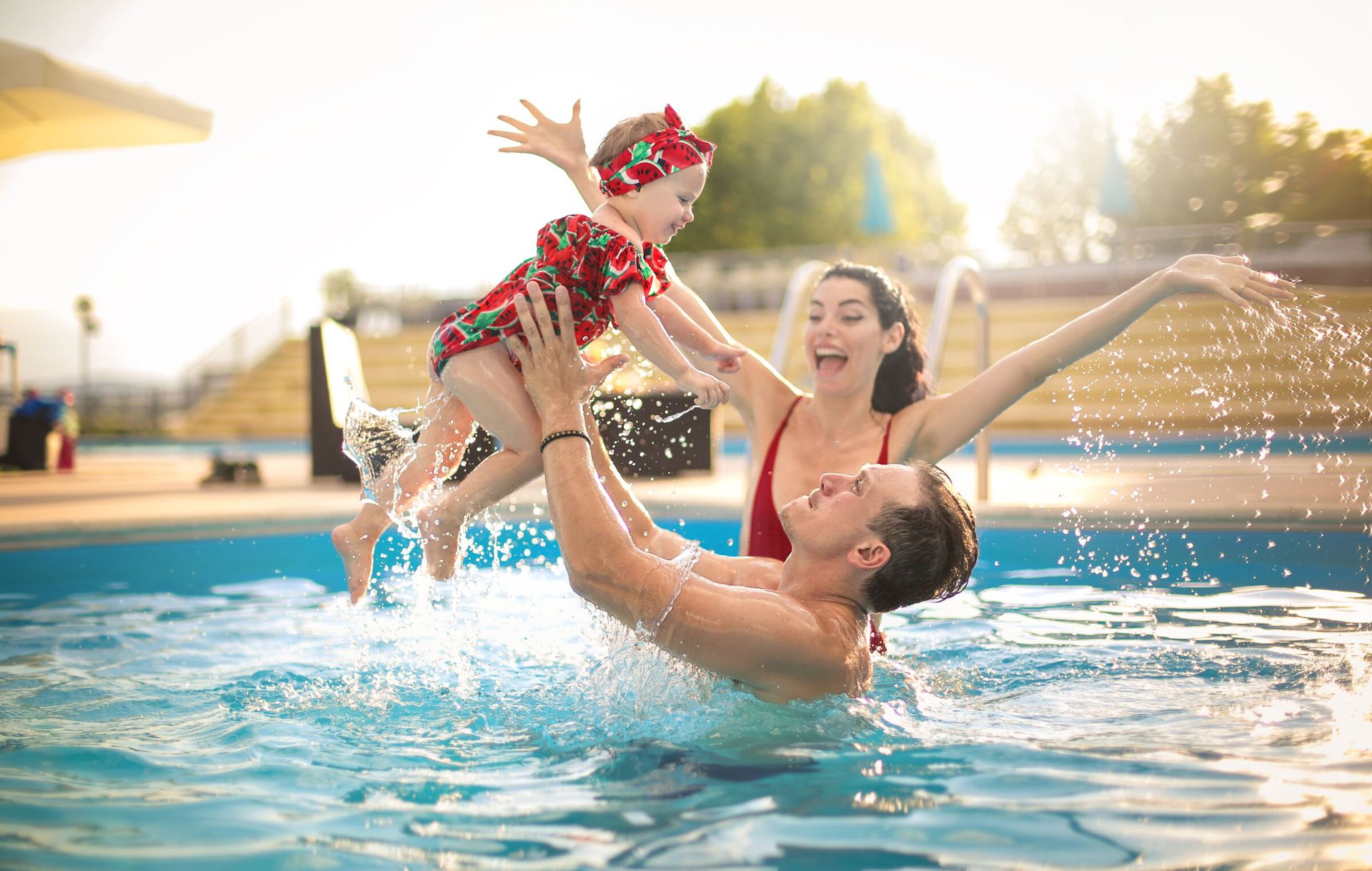 parent and baby in pool
