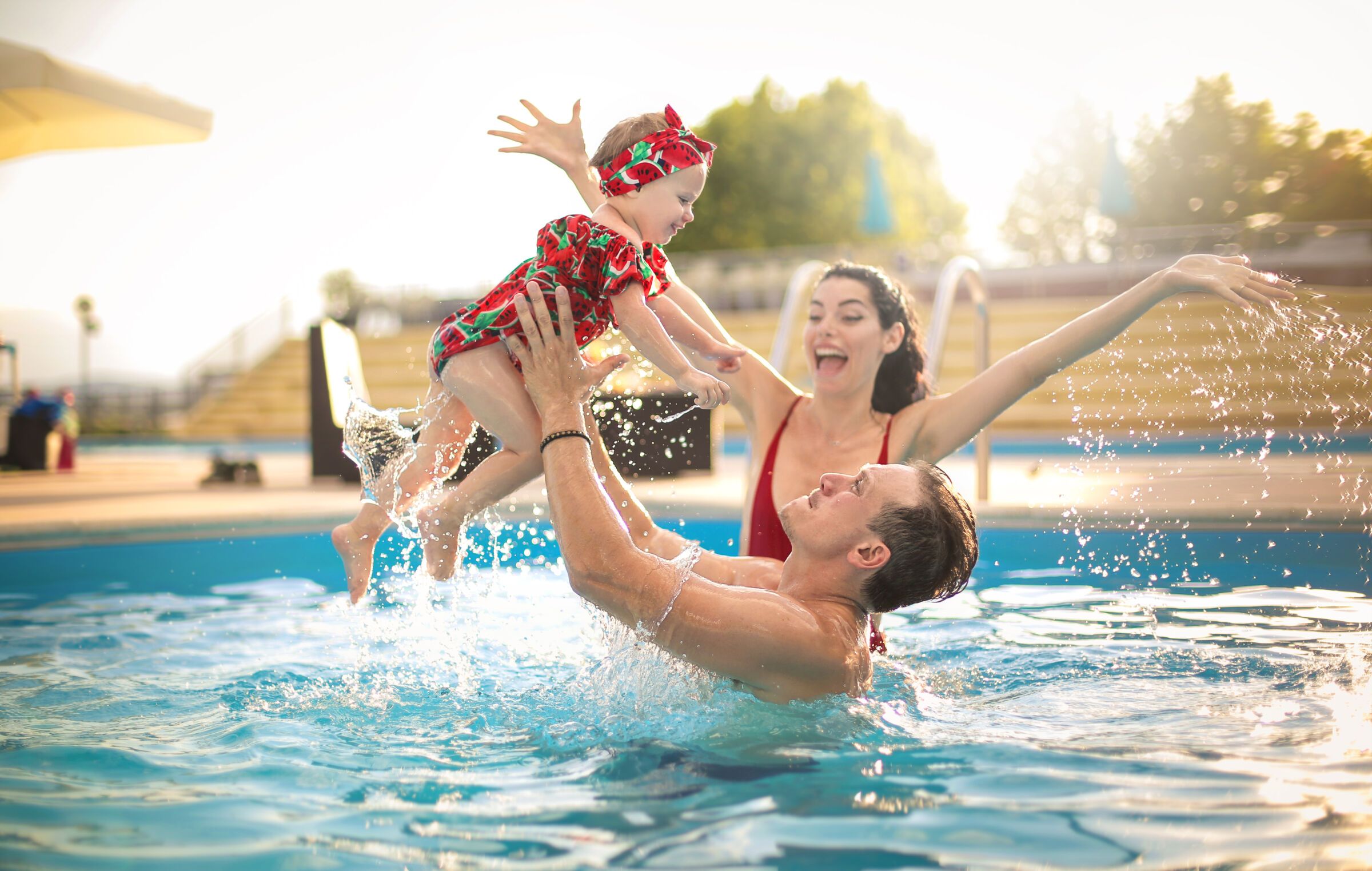 parent and baby in pool