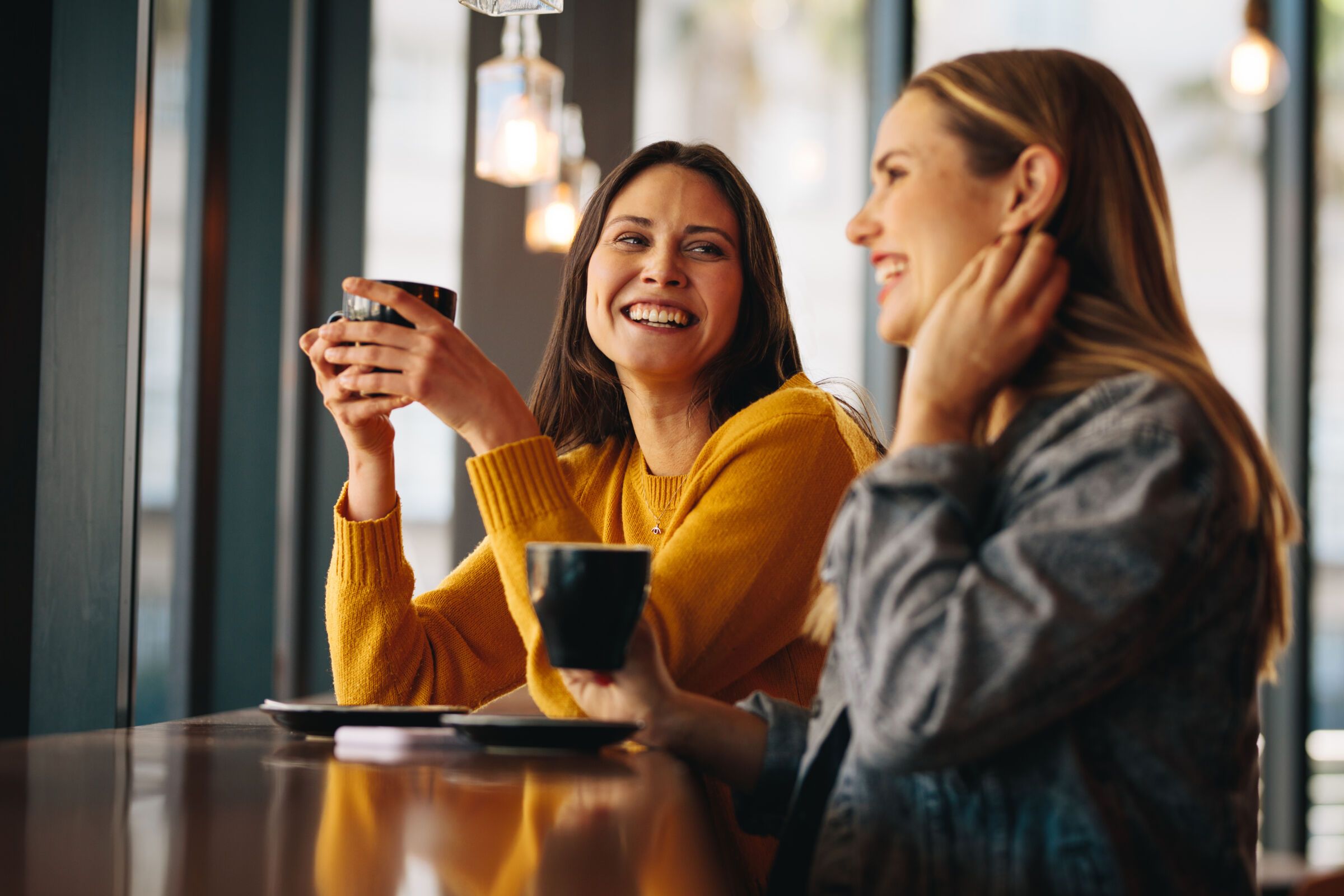 2 women getting coffee together