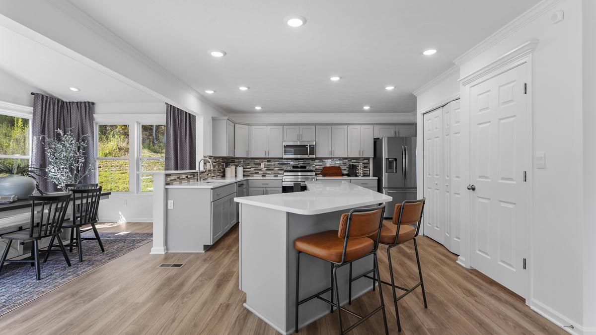 Your new kitchen has it all - Granite countertops, LVP flooring, and stainless steel appliances.