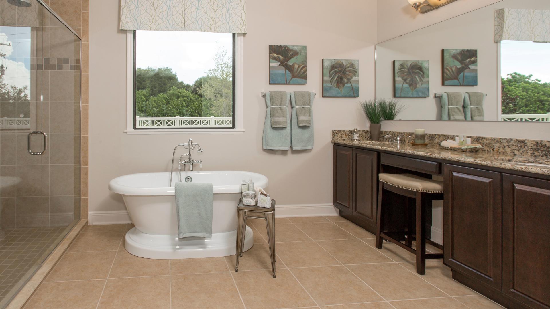 Enjoy a spa-like bathroom with dual vanities, a frameless shower, and a relaxing soaking tub.