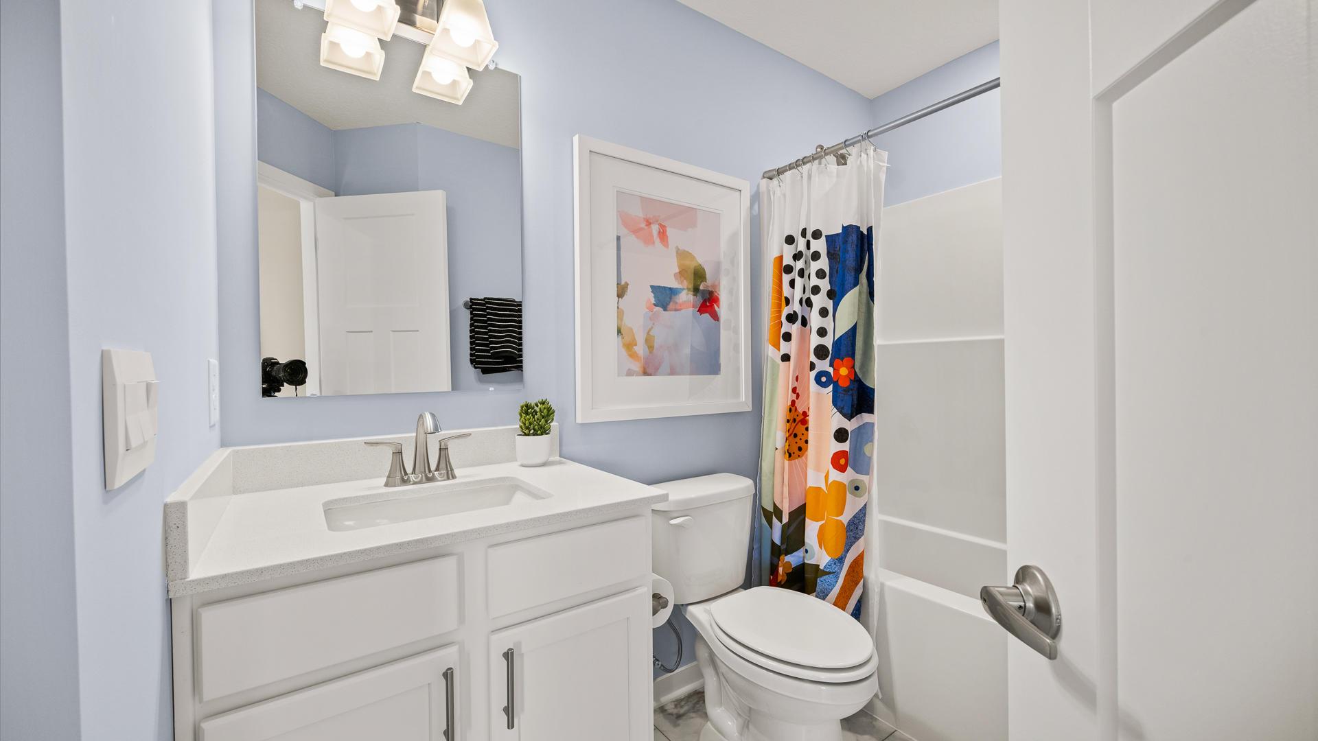 The guest bathroom ensures friends and family have their own space for comfort during visits.