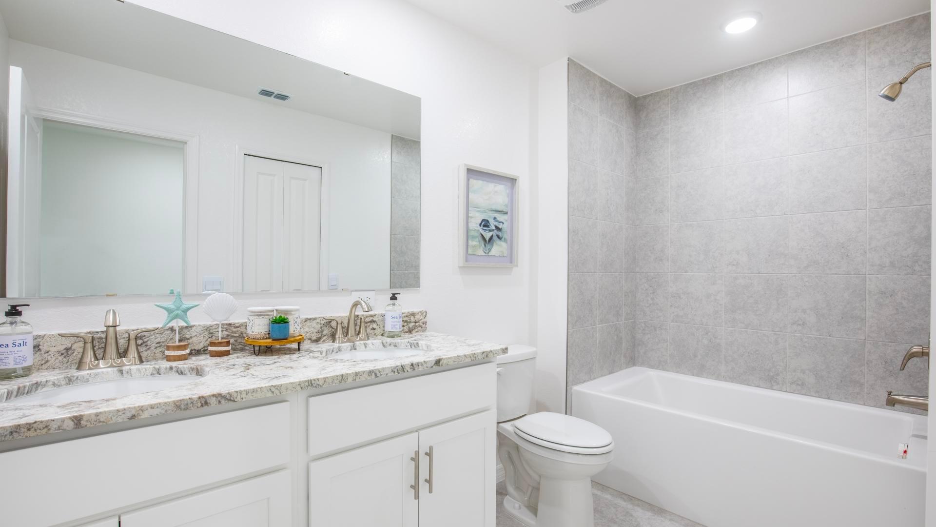 Friends and family will love the double vanity and convenient tub/shower combo for freshening up.