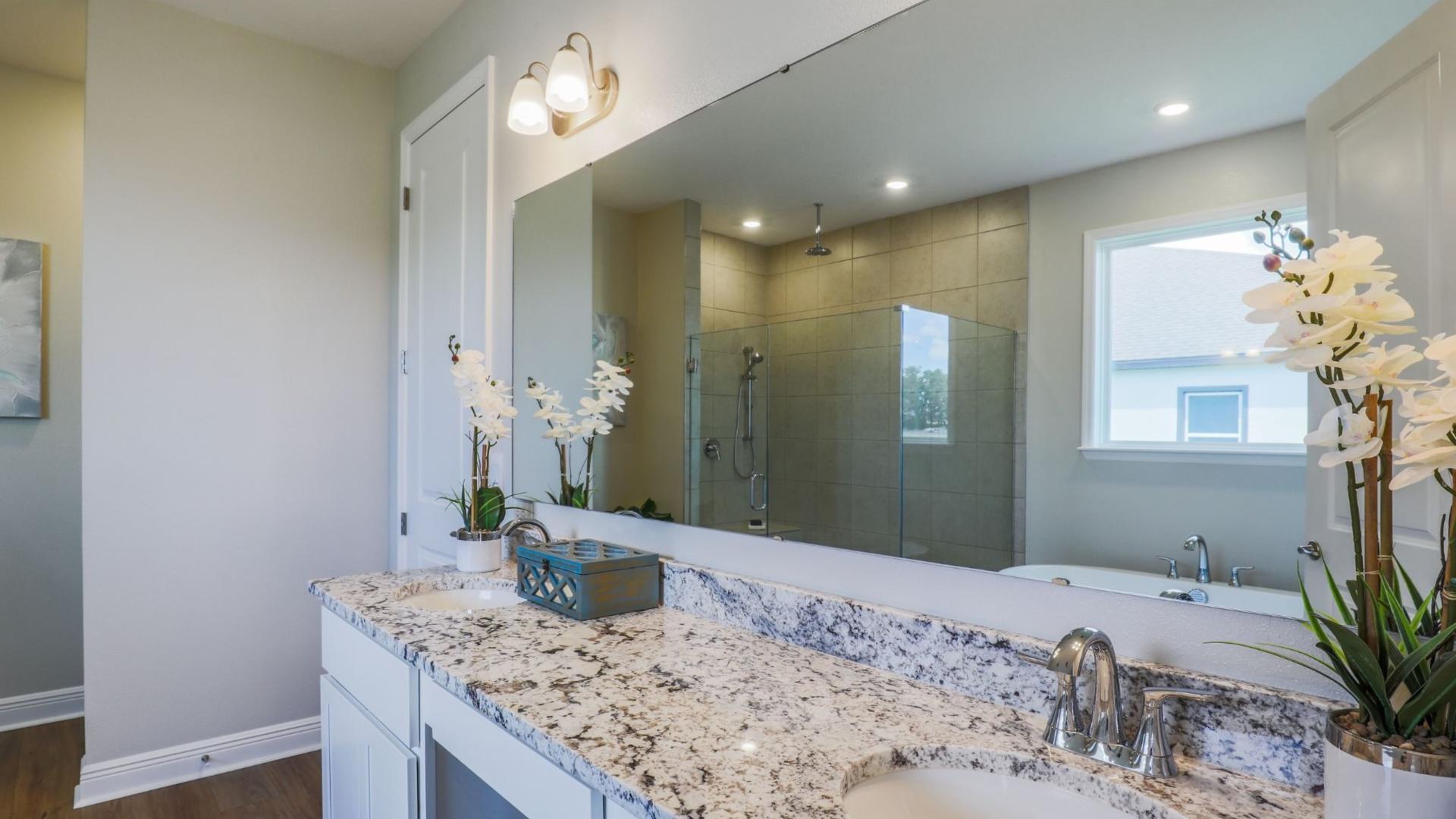 Dual vanities and walk-in shower makes getting ready in the morning easy.