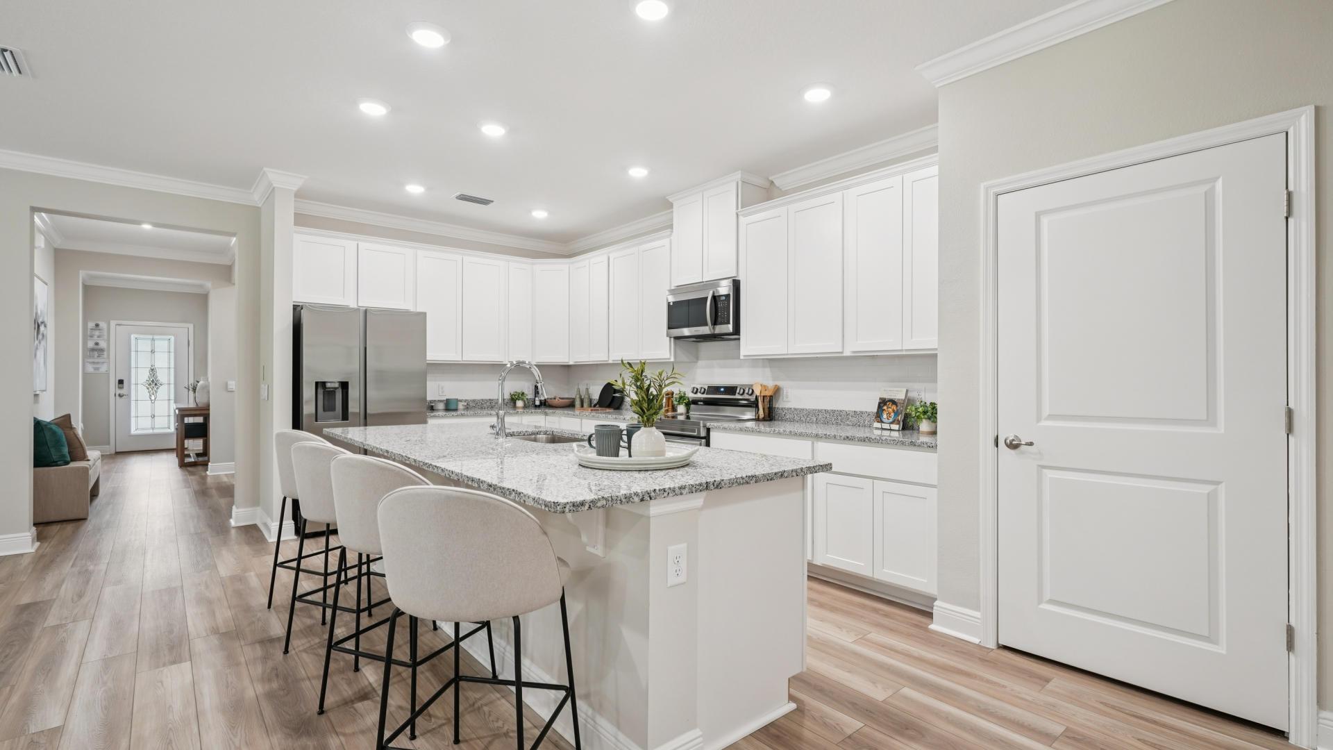 Included quartz countertops, kitchen island, EVP flooring, &amp; 42" upper kitchen cabinets.
