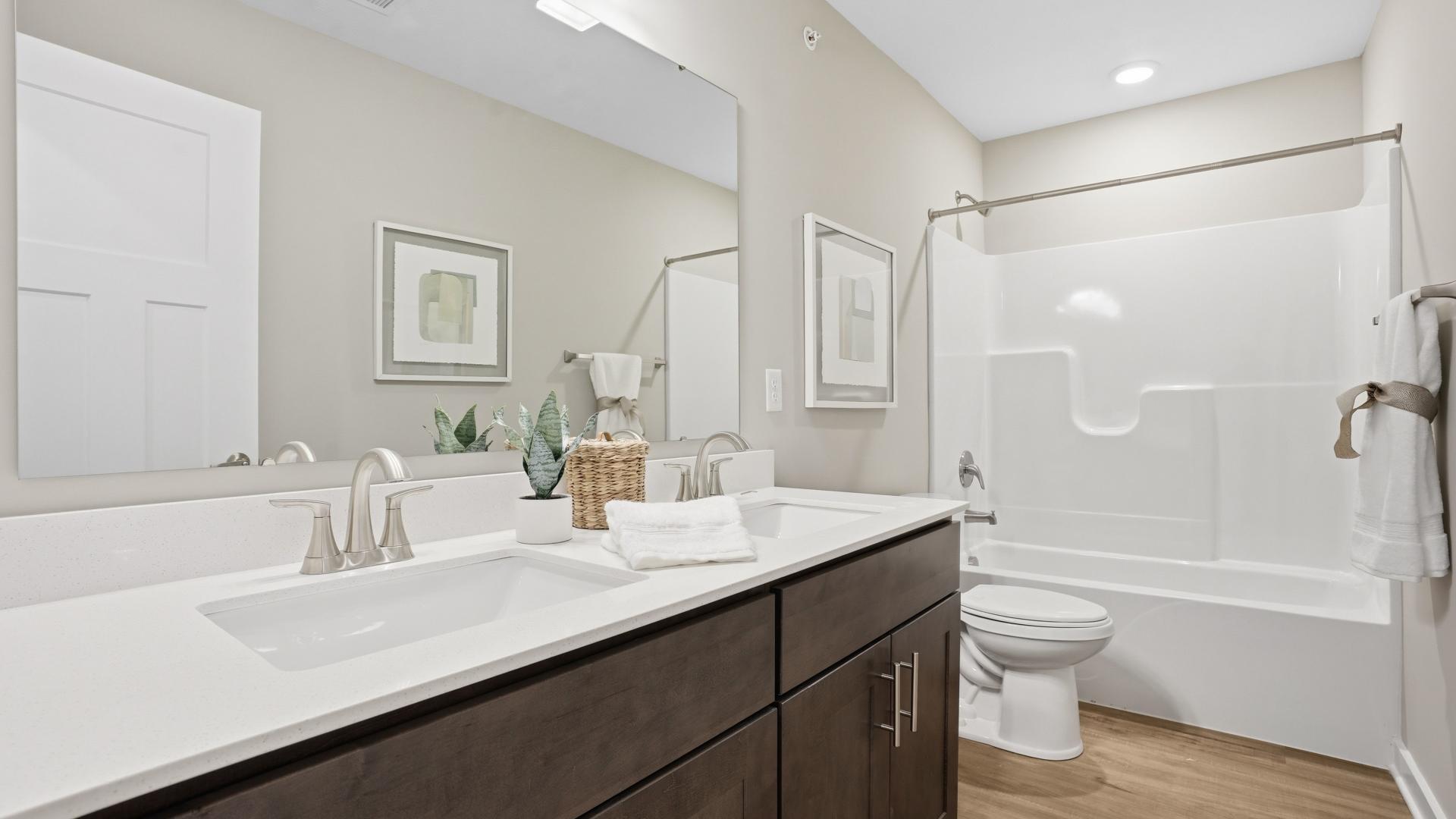 Dual vanities, frameless walk-in showers, and plenty of storage space in your master bath.