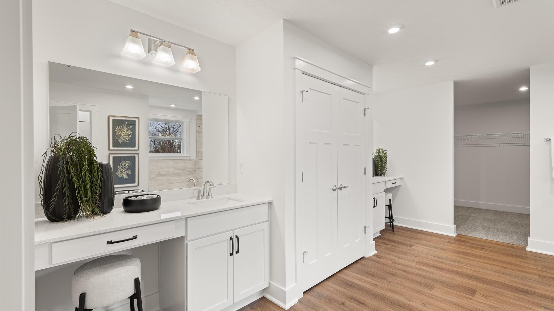 Dual vanities, walk-in tile surround showers and plenty of storage gives the master bath a spa like feel.