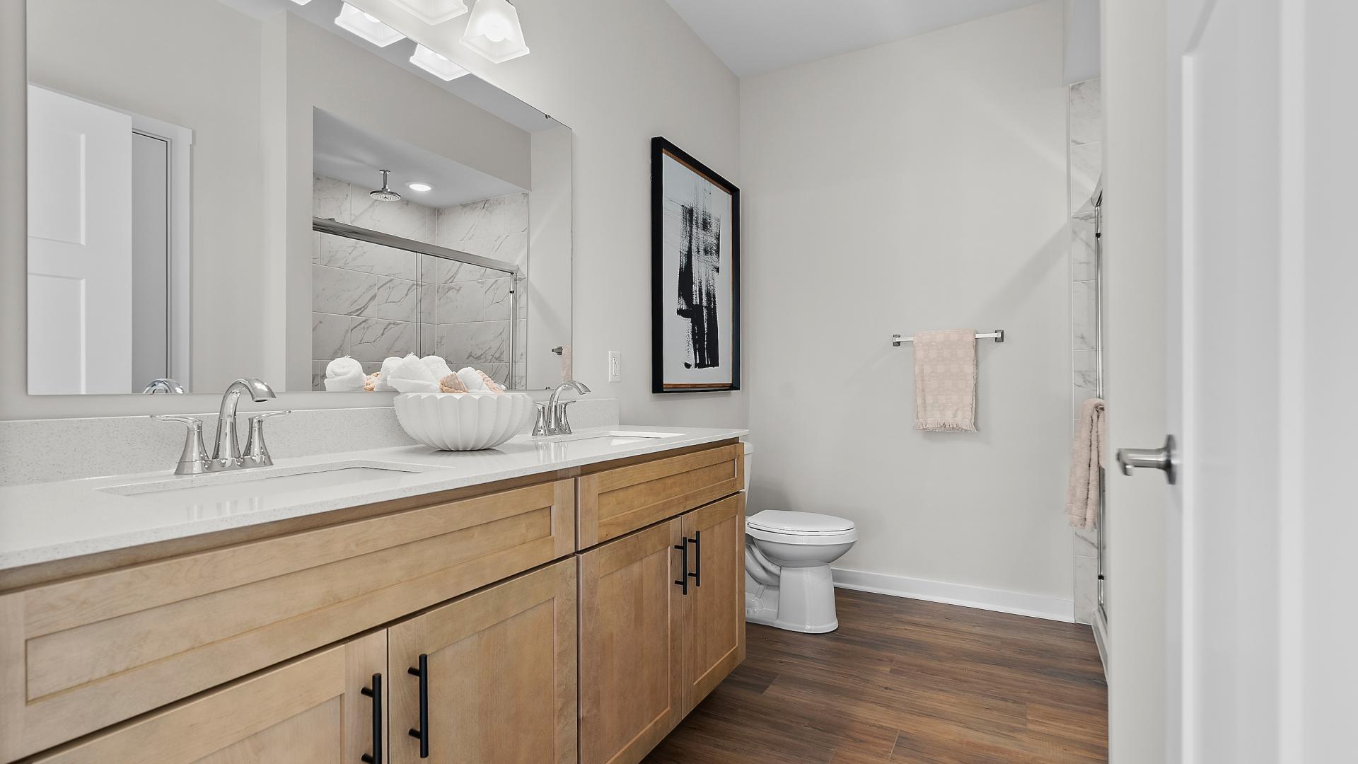 Dual vanities, walk-in tile surround showers and plenty of storage gives the master bath a spa like feel.