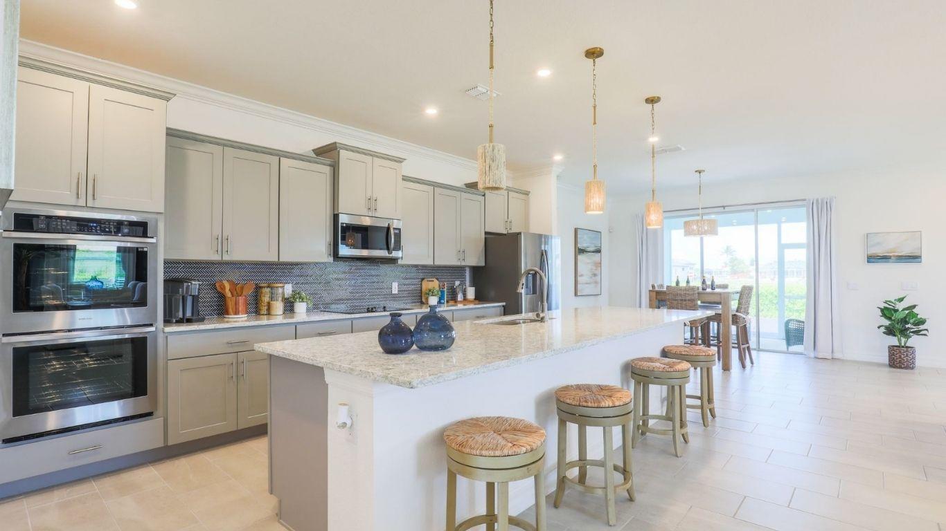Included granite countertops, kitchen island, tile flooring, &amp; 42" upper kitchen cabinets.