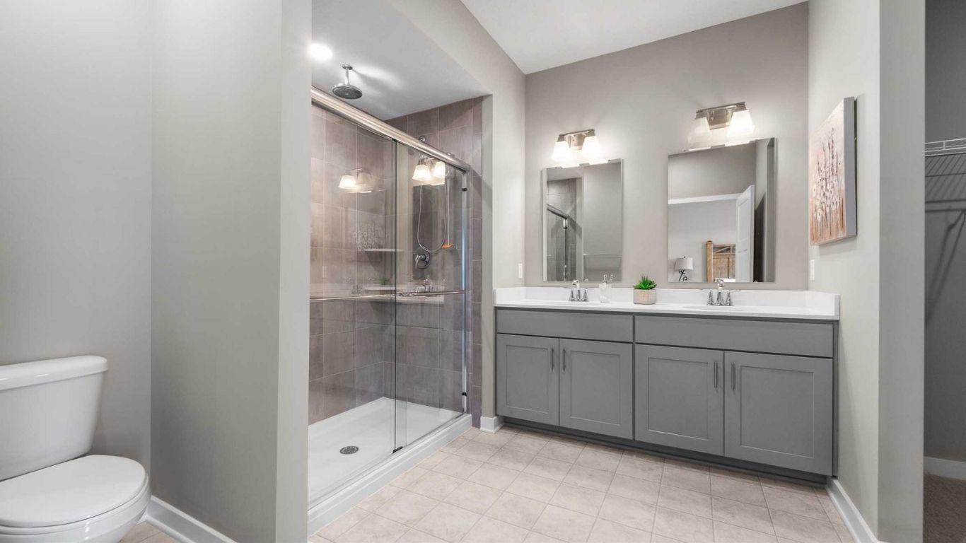 Dual vanities and walk-in showers included!